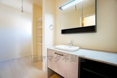 三面鏡つき洗面台。鏡裏にたっぷりとした収納スペースがあります。鏡を閉めてしまえば小物は見えないため、スッキリとした印象の洗面台にできます。