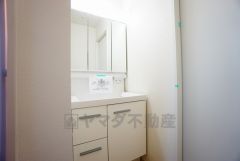 三面鏡つき洗面台。鏡裏にたっぷりとした収納スペースがあります。鏡を閉めてしまえば小物は見えないため、スッキリとした印象の洗面台にできます。